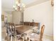 Cozy dining area featuring a wooden table, seating for six, and a decorative chandelier at 4114 Murfield E Dr, Bradenton, FL 34203