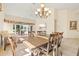 Open dining room with chandelier, neutral colors, and view into Gathering room at 4114 Murfield E Dr, Bradenton, FL 34203