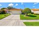 Charming single-story home with a well-manicured lawn, mature landscaping, and a two-car garage at 4114 Murfield E Dr, Bradenton, FL 34203