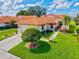 Charming single-story home with a well-manicured lawn, vibrant landscaping, and a lovely tiled roof at 4114 Murfield E Dr, Bradenton, FL 34203