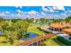 Picturesque golf course scene showcasing a charming bridge over water, lush greenery, tennis courts, and the clubhouse at 4114 Murfield E Dr, Bradenton, FL 34203