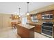 Eat-in kitchen with an island, granite countertops, tile backsplash, and stainless appliances at 4114 Murfield E Dr, Bradenton, FL 34203
