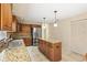 Spacious kitchen featuring an island, stainless steel refrigerator, granite countertops and wood cabinets at 4114 Murfield E Dr, Bradenton, FL 34203