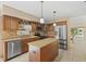 Kitchen boasting an island, granite countertops, stainless appliances, and ample cabinetry at 4114 Murfield E Dr, Bradenton, FL 34203