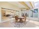 Screened lanai featuring tile flooring, ceiling fan, and open view to living and dining at 4114 Murfield E Dr, Bradenton, FL 34203