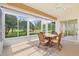 Enclosed lanai features tile floors, a ceiling fan, and views of the green backyard at 4114 Murfield E Dr, Bradenton, FL 34203