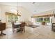 Open-concept living and dining area with tile floors, high ceilings, and access to an outdoor space at 4114 Murfield E Dr, Bradenton, FL 34203