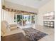 View of living room showing tile flooring, comfy seating, and sliders to the lanai at 4114 Murfield E Dr, Bradenton, FL 34203