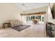 Bright living room featuring a comfortable sofa, tile floors, and a screened lanai at 4114 Murfield E Dr, Bradenton, FL 34203
