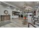 Large foyer with tables, chairs, tile floors, and high ceilings decorated with hanging chandelier lights at 4114 Murfield E Dr, Bradenton, FL 34203