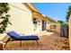 Private brick patio with a blue chaise lounge, potted plants, and a grill, perfect for relaxation at 4114 Murfield E Dr, Bradenton, FL 34203