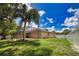 This backyard has a large, grassy area, perfect for outdoor activities and bordered by a white fence at 4150 Otoole St, North Port, FL 34291