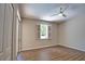 Bedroom with wood-look floors, neutral paint, ceiling fan, and sliding glass doors to lanai at 4150 Otoole St, North Port, FL 34291