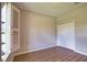 Bedroom features wood-look floors, neutral paint, shuttered window, and double closet at 4150 Otoole St, North Port, FL 34291