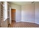 Bright bedroom features wood-look floors, closet, neutral paint, and a shuttered window at 4150 Otoole St, North Port, FL 34291