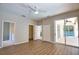 Bedroom features wood-look floors, ceiling fan, and sliding glass doors to screened pool at 4150 Otoole St, North Port, FL 34291