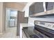 Open kitchen view with stainless steel appliances and access to the laundry room at 4150 Otoole St, North Port, FL 34291