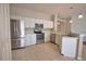 Updated kitchen boasts stainless steel appliances, white cabinets, and functional layout at 4150 Otoole St, North Port, FL 34291