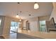 Kitchen view includes laundry room, double door pantry, and slider to pool area at 4150 Otoole St, North Port, FL 34291