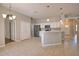 Well-lit kitchen boasts white cabinets, stainless appliances, and tile flooring for easy maintenance at 4150 Otoole St, North Port, FL 34291