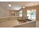 Kitchen sink and breakfast bar overlooking the sliding glass door to the pool area at 4150 Otoole St, North Port, FL 34291