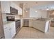 Bright kitchen features white cabinets, stainless steel appliances, and modern lighting at 4150 Otoole St, North Port, FL 34291