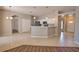 Modern kitchen featuring white cabinets, stainless steel appliances, and a breakfast bar area at 4150 Otoole St, North Port, FL 34291