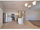 Spacious kitchen with modern stainless steel appliances, white cabinetry, and tile flooring at 4150 Otoole St, North Port, FL 34291