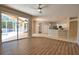 Spacious living area with sliding doors to the patio, wood-look floors, and open view to the kitchen at 4150 Otoole St, North Port, FL 34291