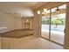 Open-concept living space featuring access to the pool area, wood-look floors, and tile flooring at 4150 Otoole St, North Port, FL 34291
