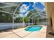 A screened pool enclosure provides a stunning view of the backyard, with a lovely pool as the focal point at 4150 Otoole St, North Port, FL 34291