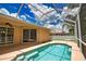 Inviting pool with built-in steps and a screened enclosure, creating a private and relaxing outdoor oasis with beautiful views at 4150 Otoole St, North Port, FL 34291