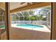 Screened lanai features sparkling pool, mature trees, and ample patio space at 4150 Otoole St, North Port, FL 34291