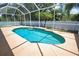 Sparkling pool area surrounded by a screen enclosure, providing a private and relaxing outdoor retreat in a tropical setting at 4150 Otoole St, North Port, FL 34291