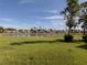 Lush backyard overlooking a peaceful pond with a fountain feature at 4831 Summertree Rd, Venice, FL 34293