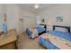 Cozy bedroom with two twin beds with blue comforters and patterned quilts at 4831 Summertree Rd, Venice, FL 34293