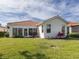 Back exterior featuring a lanai and a well maintained lawn at 4831 Summertree Rd, Venice, FL 34293