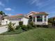 Charming single-story home featuring a red tile roof, well-manicured lawn, and an attached two-car garage at 4831 Summertree Rd, Venice, FL 34293