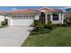 Charming single-story home featuring a red tile roof, well-manicured lawn, and an attached two-car garage at 4831 Summertree Rd, Venice, FL 34293
