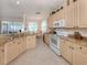 Bright kitchen features granite countertops, neutral cabinets, and modern appliances at 4831 Summertree Rd, Venice, FL 34293