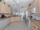 Bright kitchen features granite countertops, neutral cabinets, and modern appliances at 4831 Summertree Rd, Venice, FL 34293