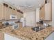Bright kitchen features granite countertops, neutral cabinets, and modern appliances at 4831 Summertree Rd, Venice, FL 34293