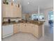 Bright kitchen features granite countertops, neutral cabinets, and modern appliances at 4831 Summertree Rd, Venice, FL 34293