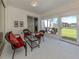 Relaxing screened lanai with wicker furniture and views of the backyard and pond at 4831 Summertree Rd, Venice, FL 34293