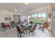 Comfortable lanai features views of the pond, a ceiling fan and a dining set at 4831 Summertree Rd, Venice, FL 34293