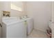 Practical laundry room with washer, dryer, and neutral walls and tile flooring at 4831 Summertree Rd, Venice, FL 34293
