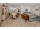 Spacious living and dining area featuring neutral carpet, a chandelier, and comfortable furnishings at 4831 Summertree Rd, Venice, FL 34293