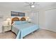 Bright bedroom features a wicker headboard, two closets, and tile flooring at 500 Park S Blvd # 33, Venice, FL 34285