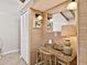 Cozy desk nook with a mirror, lighting, and a wicker chair for a comfortable workspace at 500 Park S Blvd # 33, Venice, FL 34285