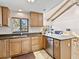 A well-lit kitchen features granite counters, stainless steel appliances, and wooden cabinetry at 500 Park S Blvd # 33, Venice, FL 34285